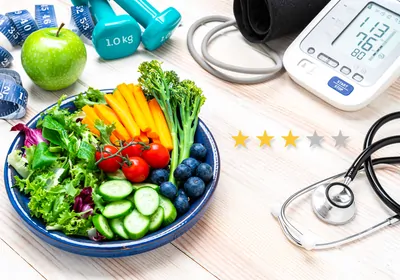 a three star rating displays next to a bowl of fruits and vegetables with a stethoscope, scale, and other health and fitness supplies in the background. a three star rating displays next to a bowl of fruits and vegetables with a stethoscope, scale, and other health and fitness supplies in the background.